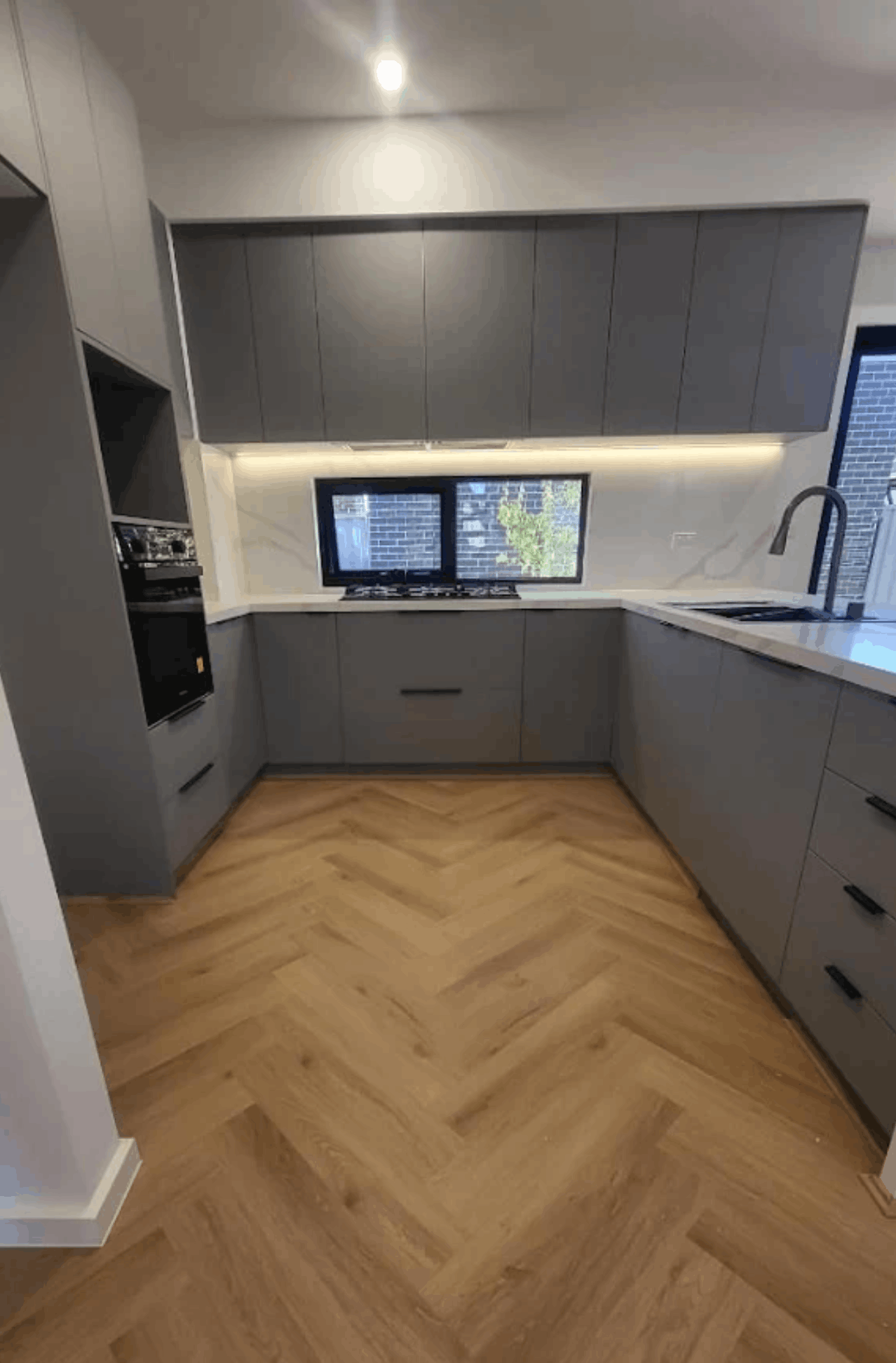 Herringbone hybrid timber floor installed in a Melbourne residential kitchen